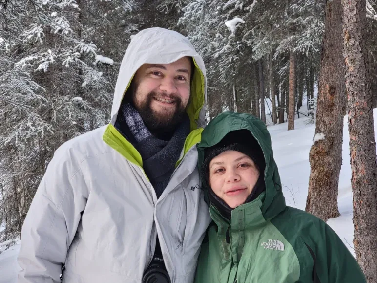 Lizbeth Chase and her brother Eduardo Gutierrez together in a snowy pine forest